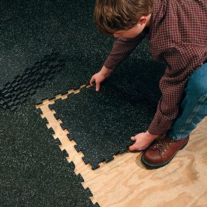 Interlocking rubber flooring shown during installation process