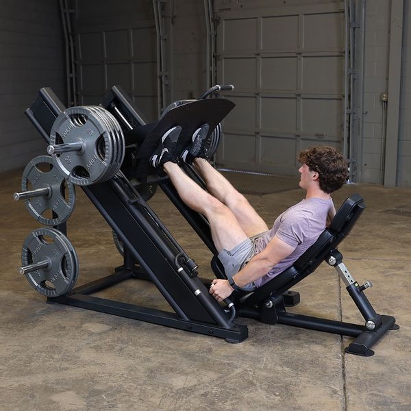 Commercial leg press machine featuring angled sled and footplate
