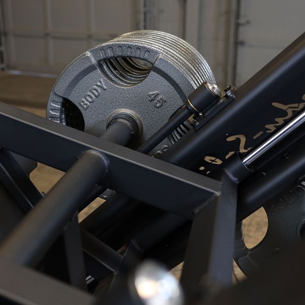 Strengthening legs with a reinforced plate loaded leg press sled system