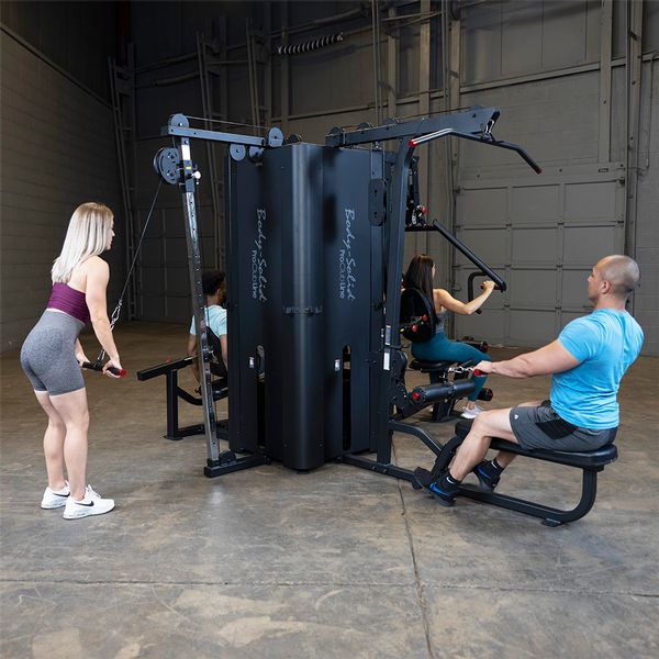 Training different muscle groups with a four stack multi station gym
